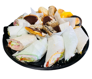 Freshly made breakfast wrap with eggs, bacon, and hash browns on a white plate.