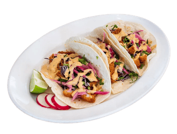 Crispy Baja fish tacos in warm tortillas topped with pickled red cabbage slaw, creamy chipotle sauce, fresh cilantro, lime, and radishes