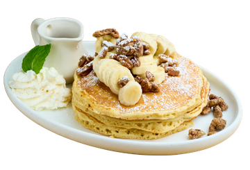 Pancakes topped with sliced banana, candied pecans, and powdered sugar at Seymour's Cafe in Livingston, NJ