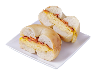 Freshly toasted plain bagel sandwich with scrambled egg and bacon on a white square dish.